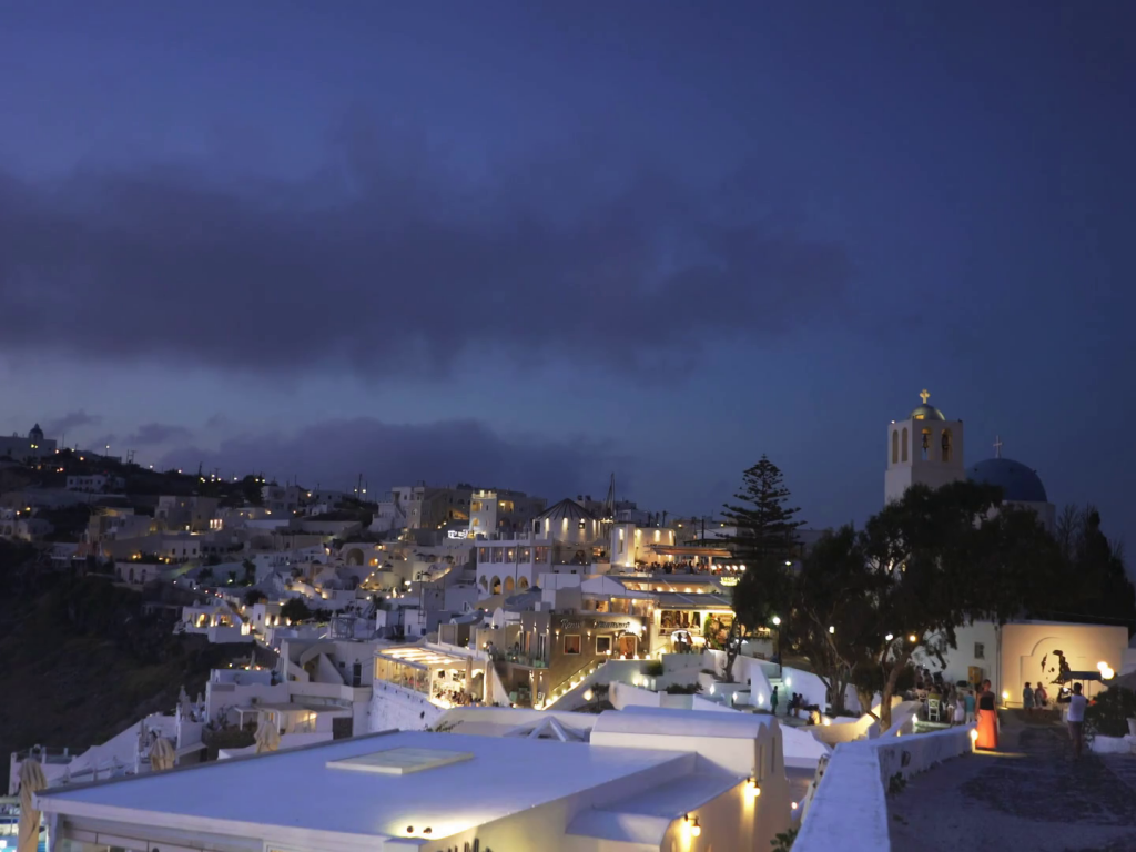 night-time-pan-from-fira-to-the-village-of-imerovigli-santorini greek best villas com